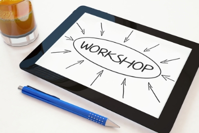 A tablet next to a pencil, and the word workshop on the screen.